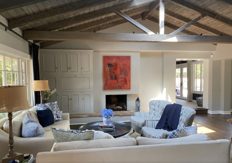 Open living room with vaulted ceiling and exposed wood beams