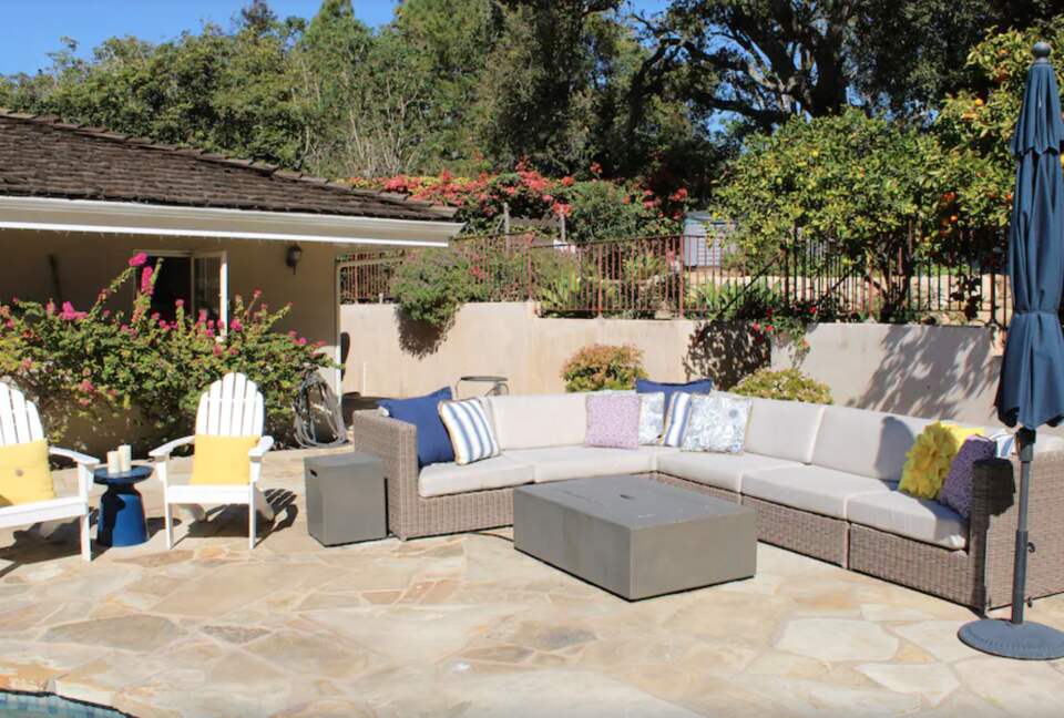 Backyard pool with plenty of seating and umbrellas