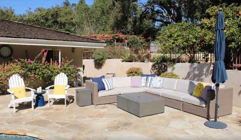 Backyard pool with plenty of seating and umbrellas