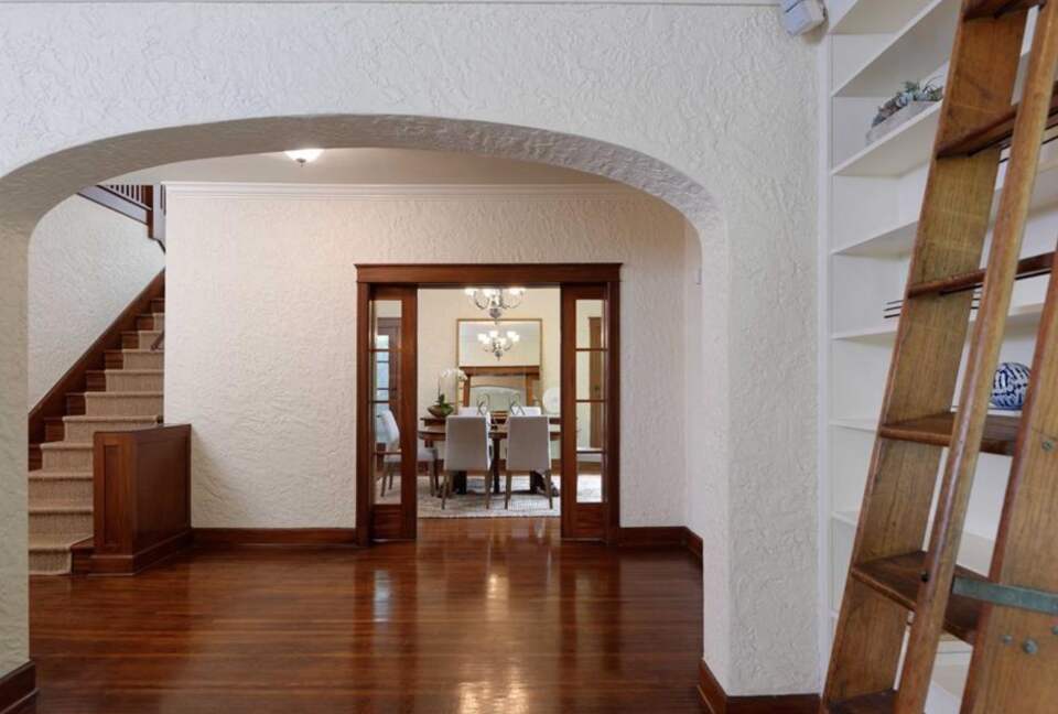 Entryway with hardwood floors and library ladder