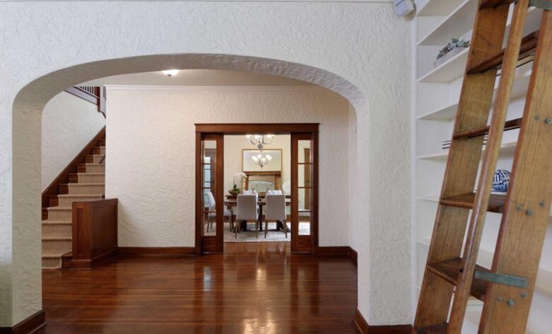 Entryway with hardwood floors and library ladder