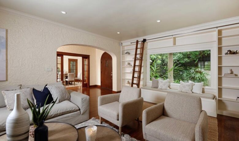 Living room with hardwood floors and library ladder