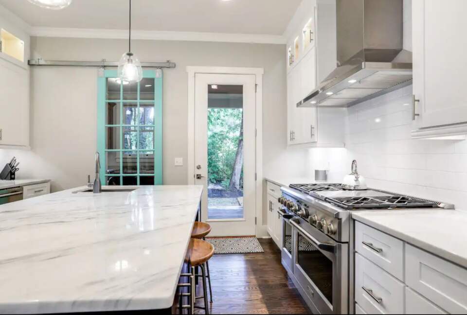 Chef's kitchen with granite countertops and large island