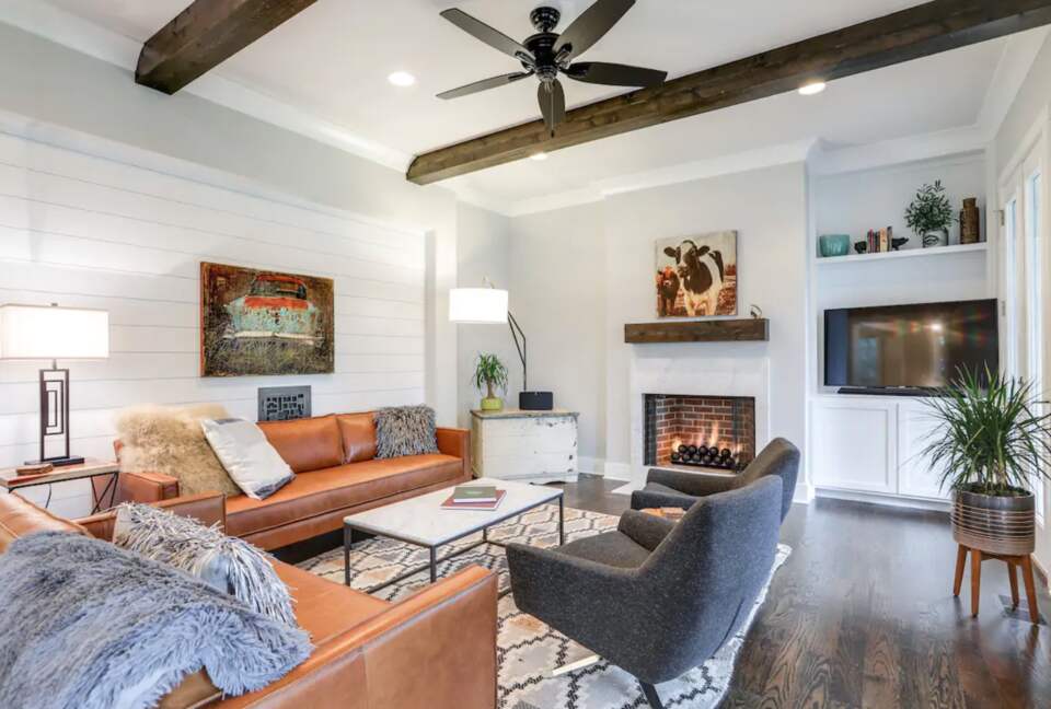 Living room with hardwood floors, fireplace and wood beams