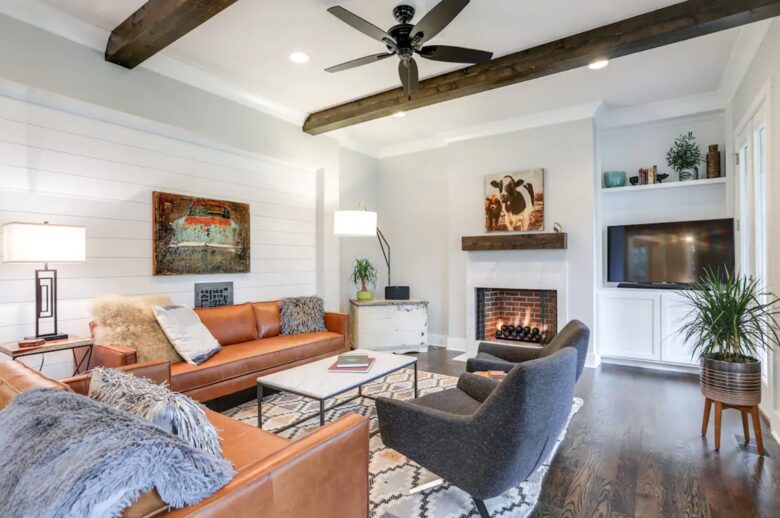 Living room with hardwood floors, fireplace and wood beams