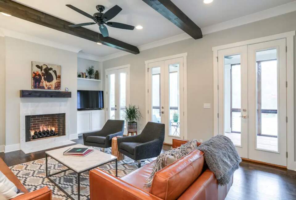 Living room with hardwood floors, fireplace and wood beams