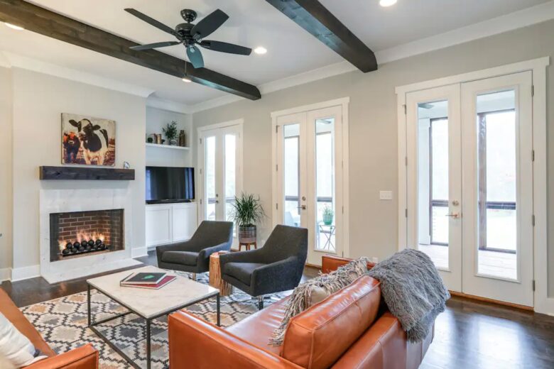 Living room with hardwood floors, fireplace and wood beams