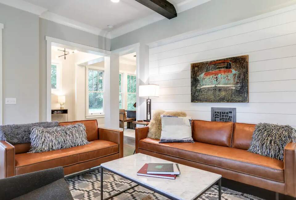 Living room with hardwood floors, fireplace and wood beams