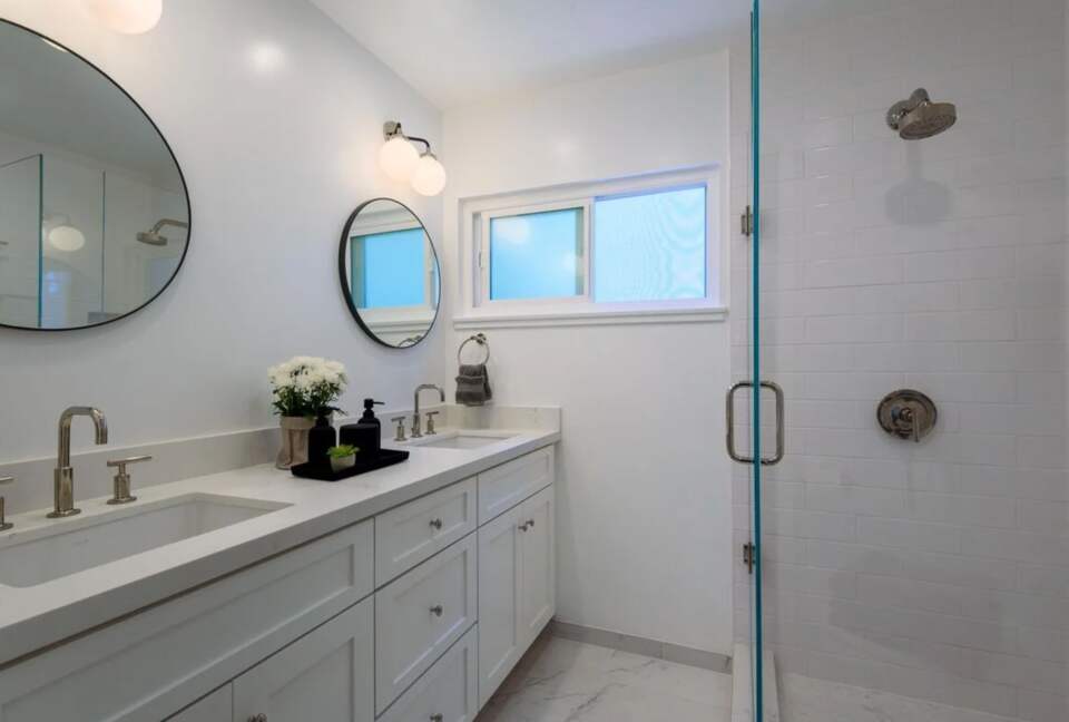 Master bathroom with double vanities and walk-in shower