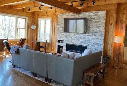 Home Exchange in Fairway, NC, living room with cozy sectional and fire