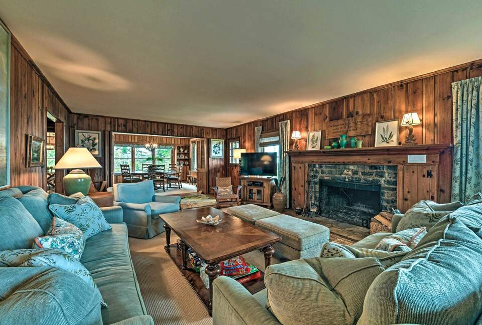 Main living room with stone fireplace and smart TV
