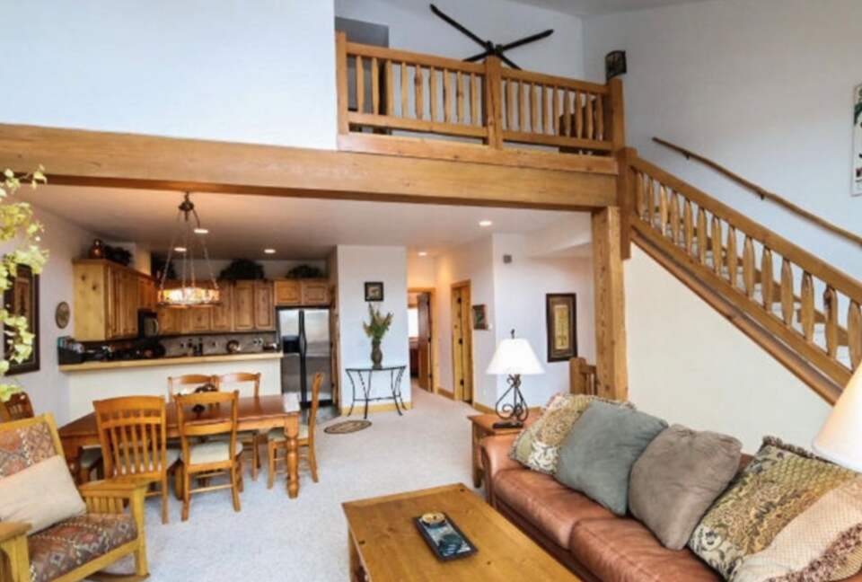 Open living room with fireplace and mountain views