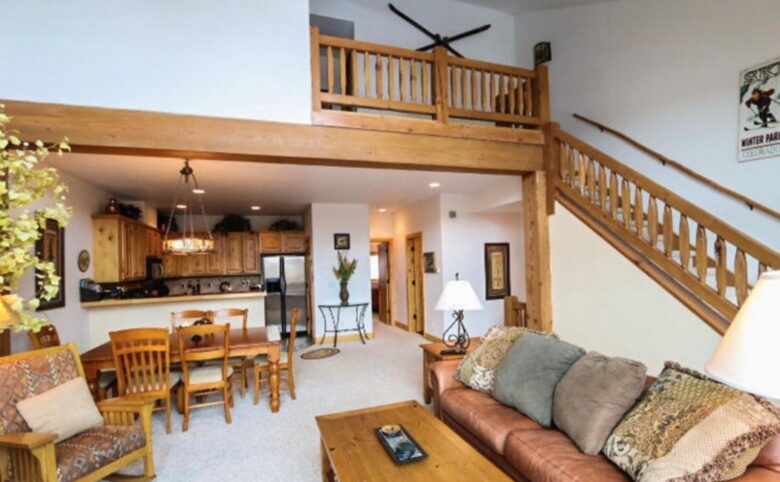 Open living room with fireplace and mountain views