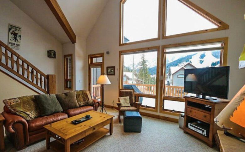 Open living room with fireplace and mountain views