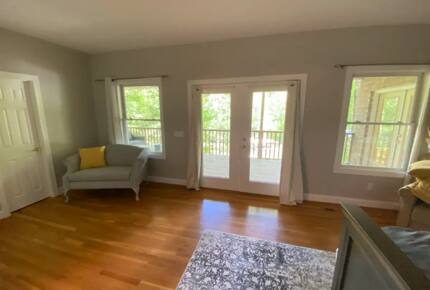 Home Exchange in Winchester, TN master bedroom seating area with deck