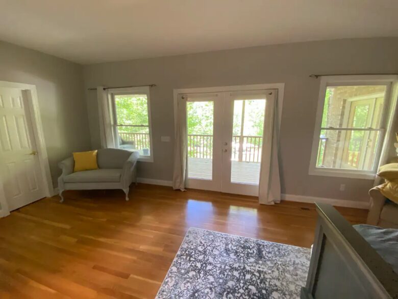 Home Exchange in Winchester, TN master bedroom seating area with deck