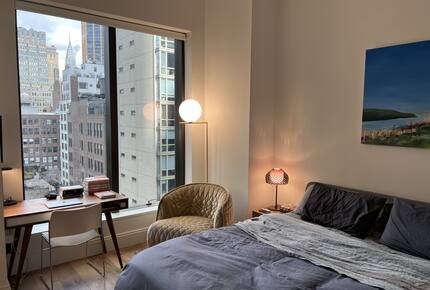 Master bedroom with workspace overlooking the city