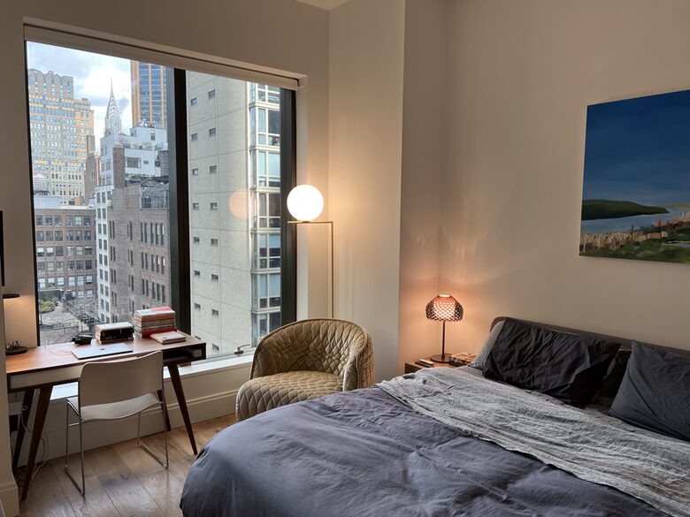 Master bedroom with workspace overlooking the city