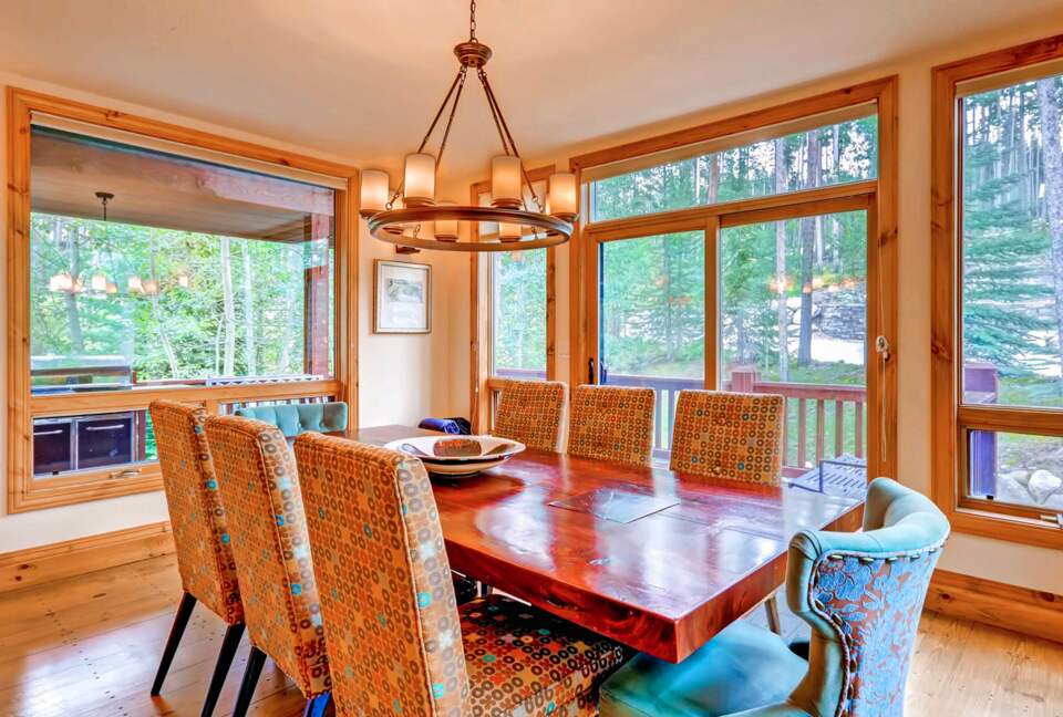 Formal dining room with forest views