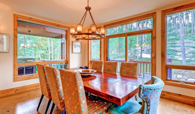 Formal dining room with forest views