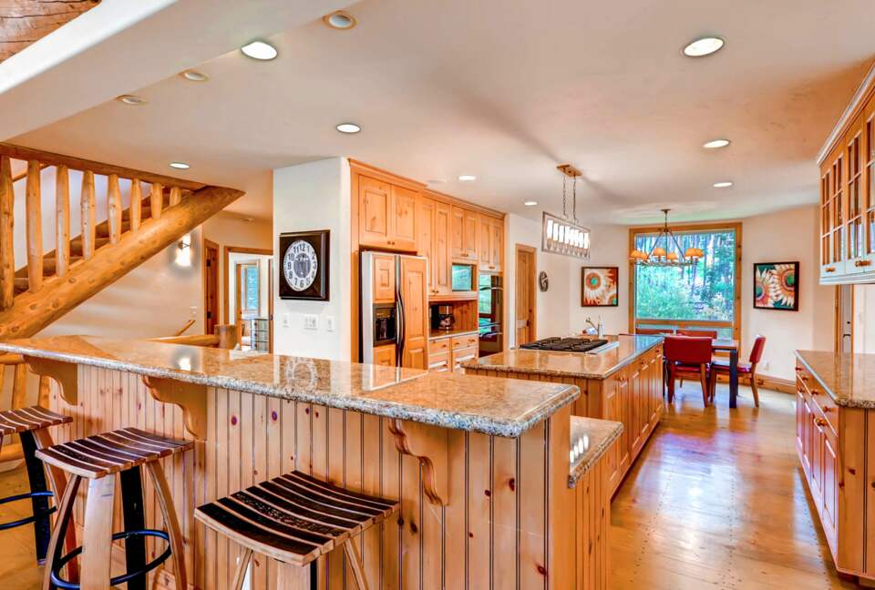 Chef's kitchen with eat-in bar for three