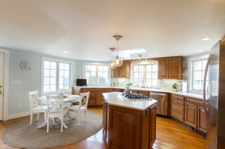 Large Kitchen with Glass Subway Tiles and Stainless Steel Appliances