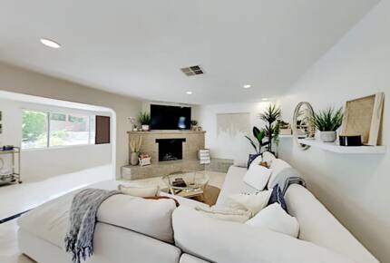 Home Exchange in Palm Springs, CA fireplace and television in living