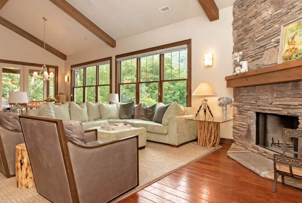 Open living room with stone fireplace