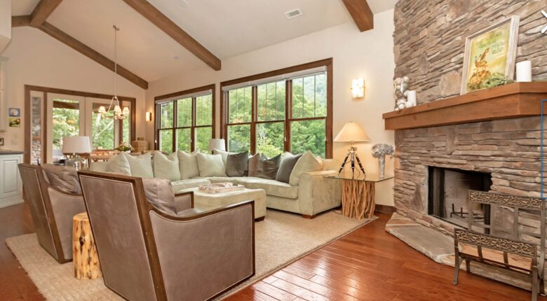 Open living room with stone fireplace