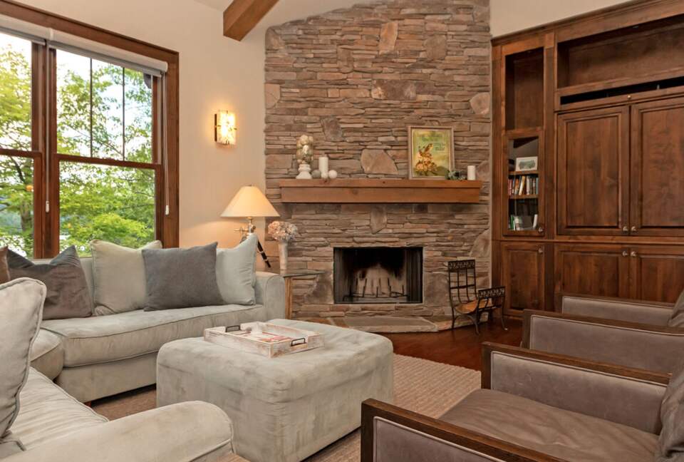 Open living room with stone fireplace