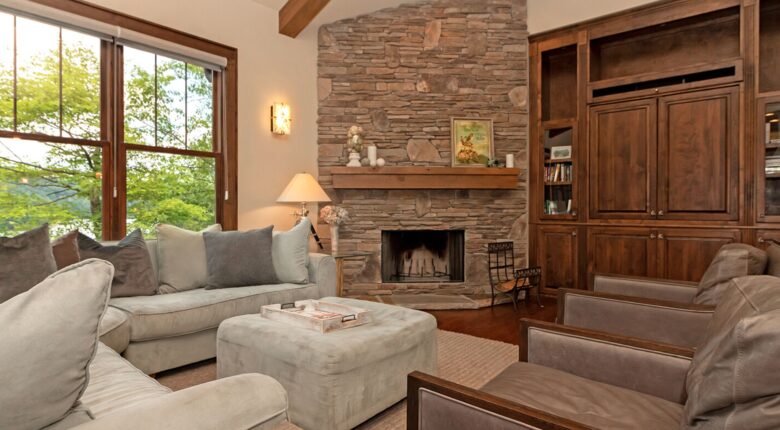 Open living room with stone fireplace