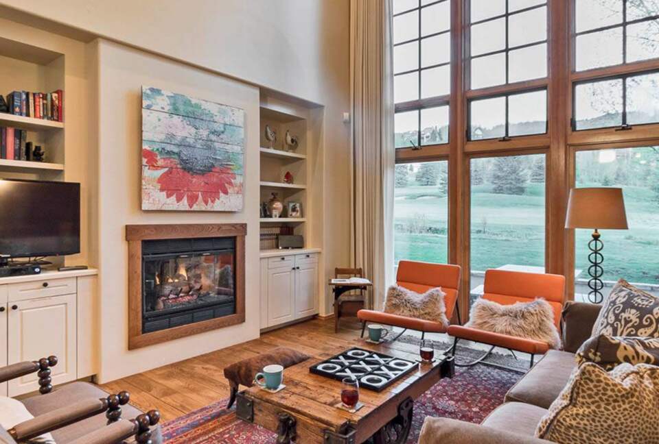 Open living room with views of the golf course and mountains