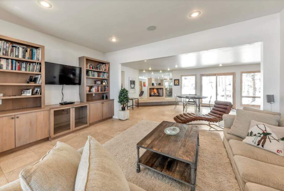 Open living room with fireplace and media