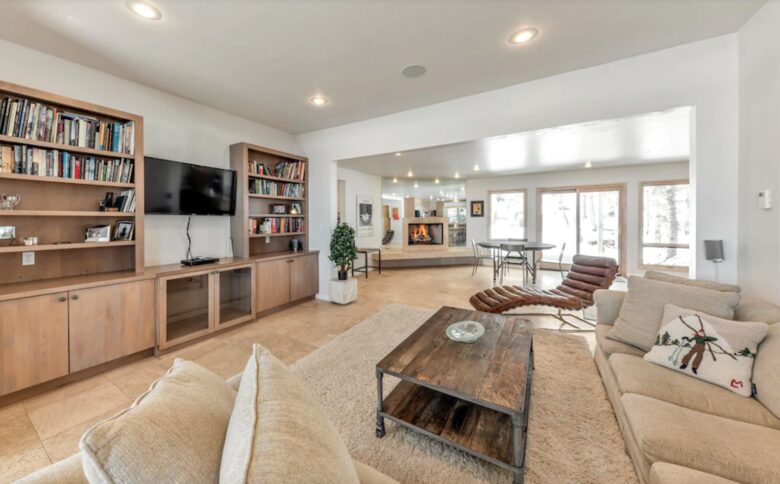 Open living room with fireplace and media