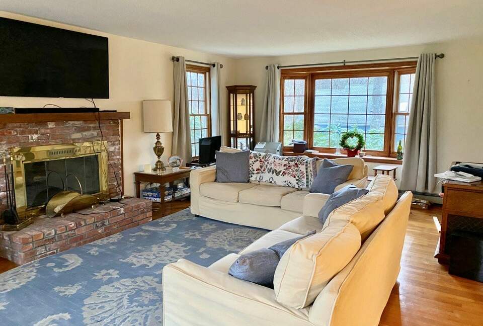 Home Exchange in North Falmouth, MA, living room with a fireplace