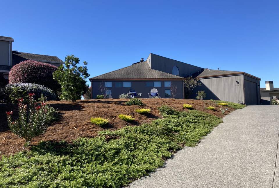 Updated driveway with landscape entrance from street.