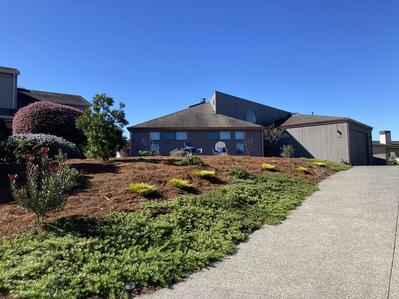 Updated driveway with landscape entrance from street.