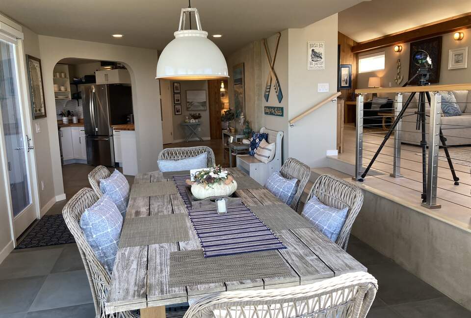 Dining area looking into kitchen and front entrance.