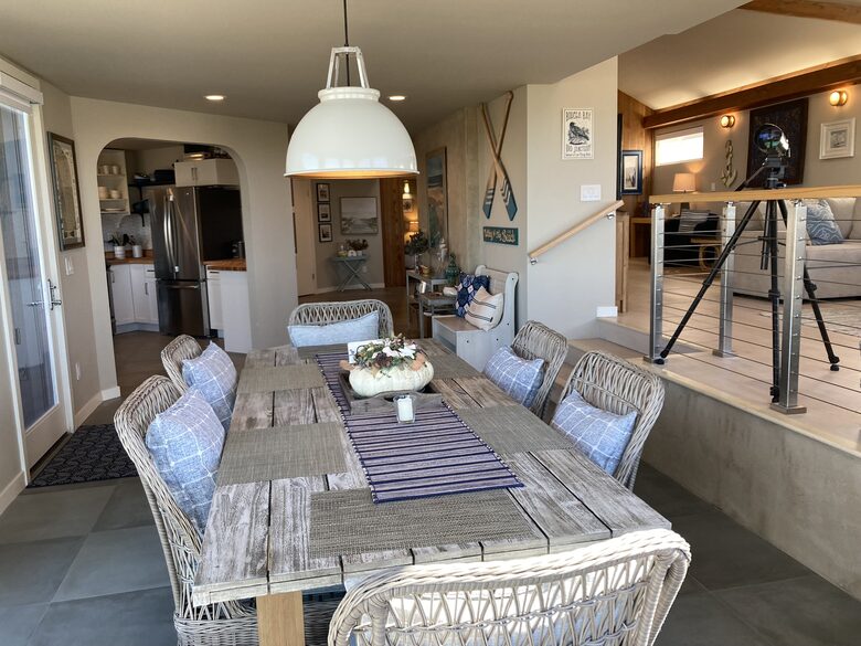 Dining area looking into kitchen and front entrance.