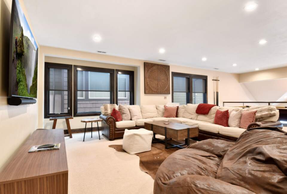 Loft with large sofa and pool table