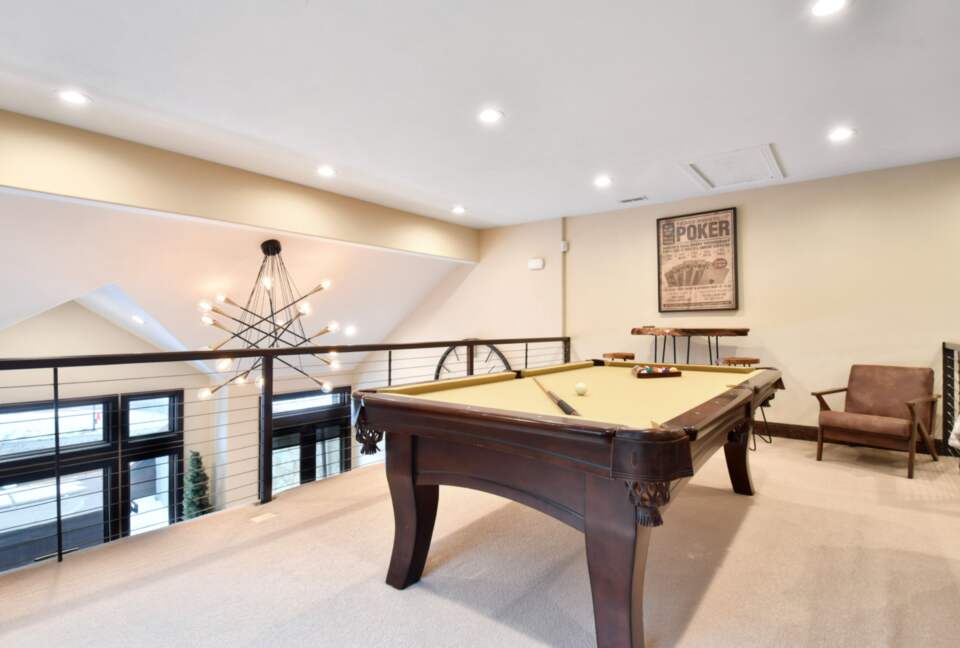 Loft with large sofa and pool table