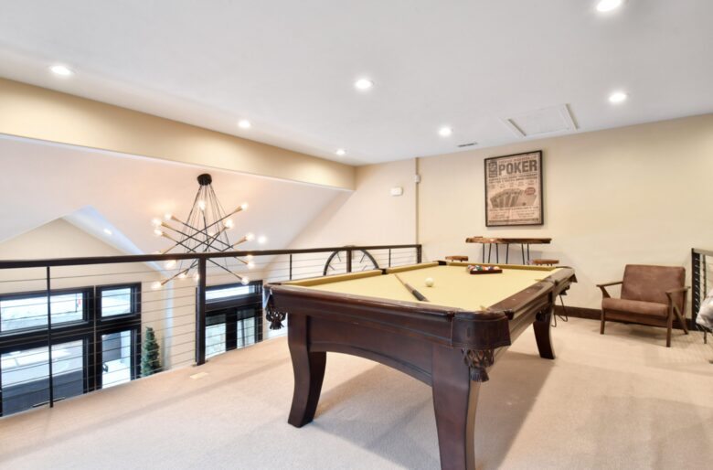 Loft with large sofa and pool table