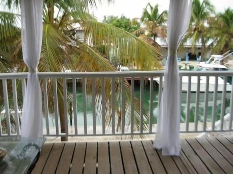Home Exchange in Marathon, FL patio view of coconut trees and water
