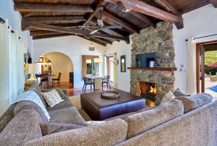Home Exchange in Palm Springs, CA family room with stone fireplace