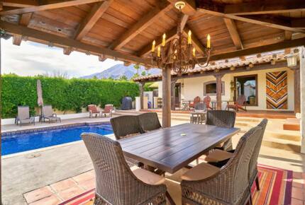 Home Exchange in Palm Springs, CA dining table under the pergola