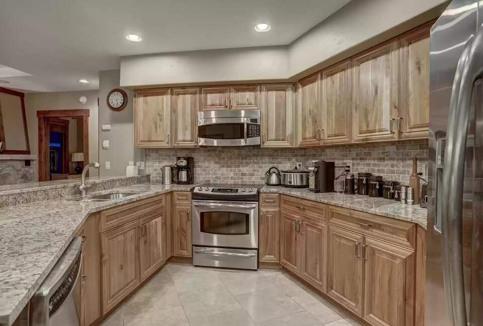 Kitchen with granite countertops and cherry cabinetry