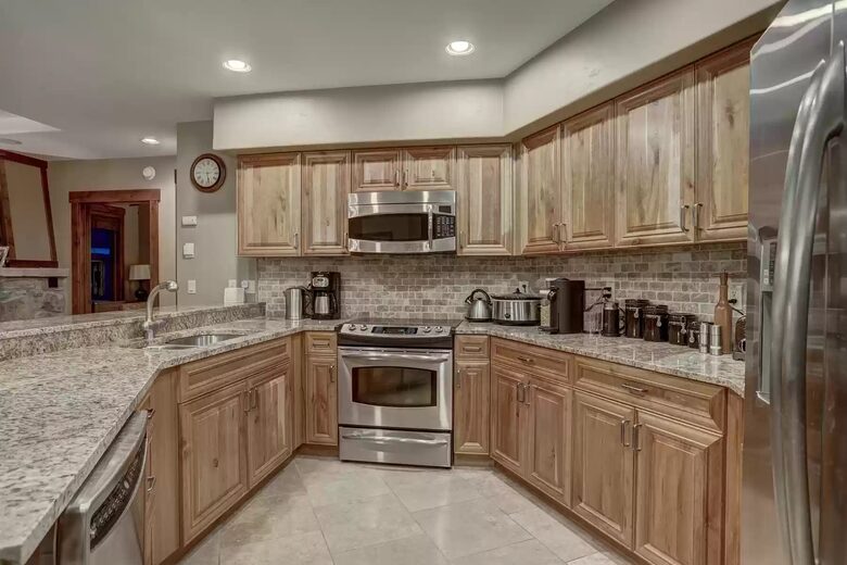 Kitchen with granite countertops and cherry cabinetry
