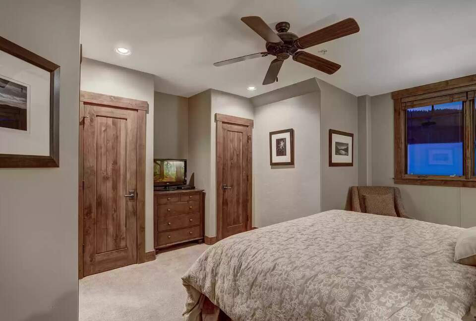 Bedroom 1 with ensuite bathroom and view of slope