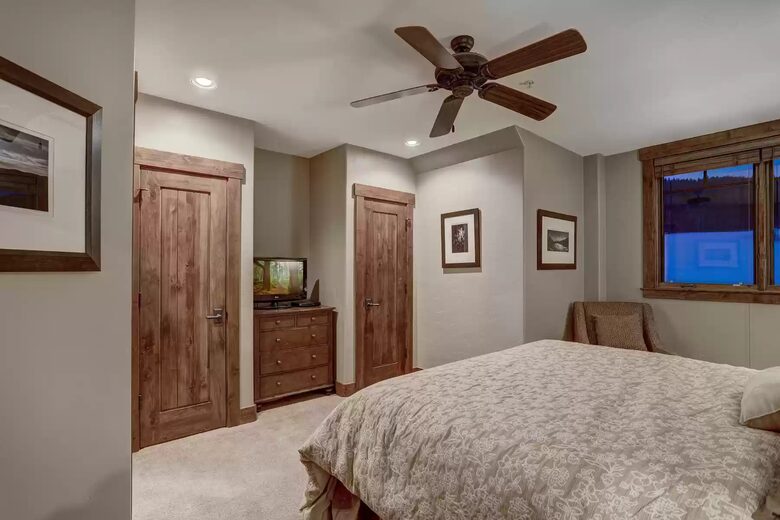 Bedroom 1 with ensuite bathroom and view of slope