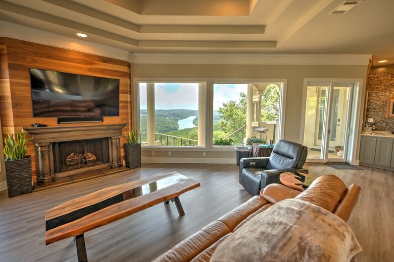 Home Exchange in Austin, TX family room with a fireplace & large tv